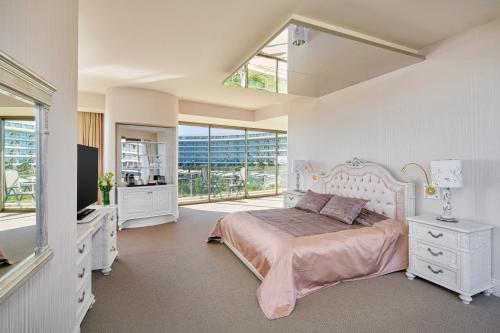 a bedroom with a bed and a large window at Maxx Royal Belek Golf Resort in Belek