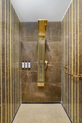 a bathroom with a shower with a shower head at Maxx Royal Belek Golf Resort in Belek