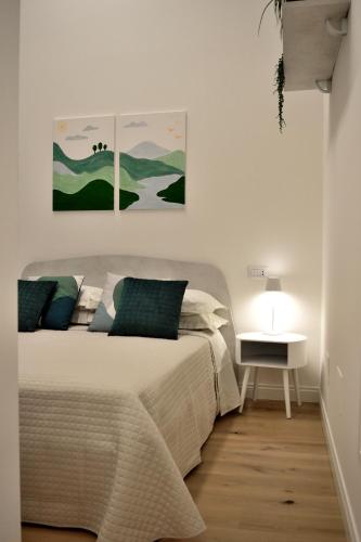 a bedroom with a bed and two paintings on the wall at B&B Case Bianche in Maranello