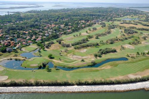 an aerial view of the golf courses at the lake at Isola di Albarella Golf Hotel in Isola Albarella