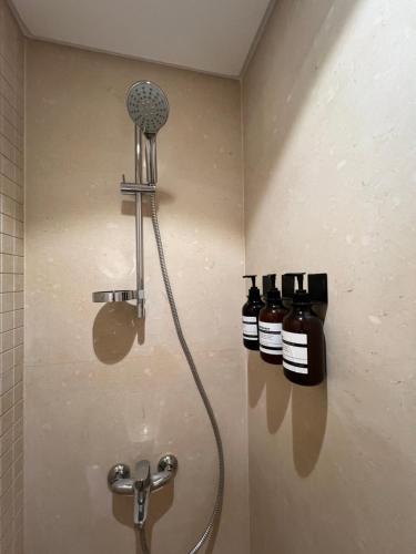 a shower in a bathroom with two bottles of alcohol at Mangroovy Seafront condo - Great Kite Surfing in Hurghada