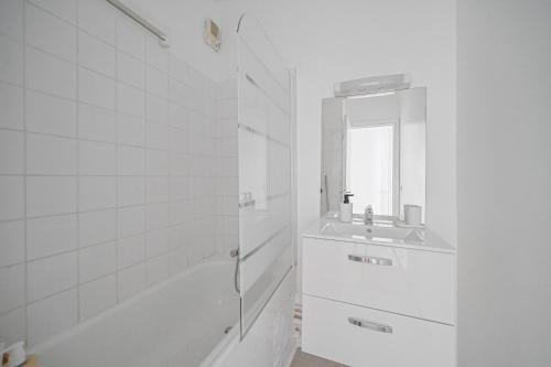 a white bathroom with a sink and a shower at Le Ruby D'Hauteville - Coeur de Paris - Unique - Spacieux 6 couchages in Paris