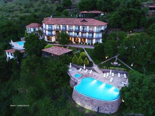 an aerial view of a mansion with a swimming pool at Vardzia Resort in Vardzia