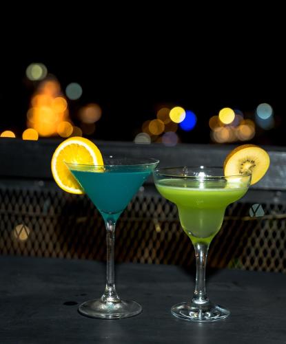 two cocktails sitting on top of a table at CHECK inn Phnom Penh BKK1 in Phnom Penh