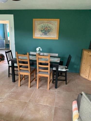 a dining room with a table and four chairs at Hofesh in Altdorf