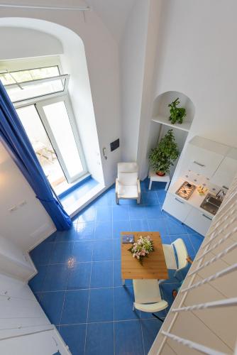 a room with a blue tile floor and a table and chairs at Alfieri Rooms - Amalfi coast in Atrani