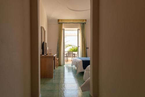 a view of a bedroom with a bed and a window at Hotel Albatros in Ischia