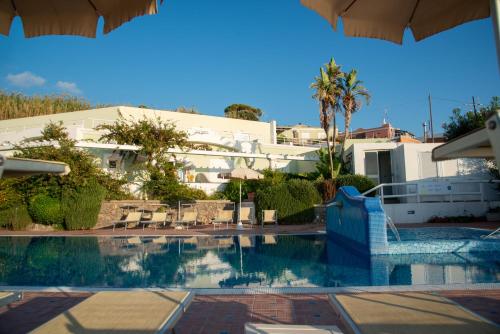a swimming pool in front of a building at Hotel Albatros in Ischia