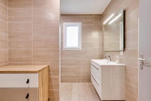 a bathroom with a sink and a mirror at Calme et serenite pour une escape a 6 in Commequiers