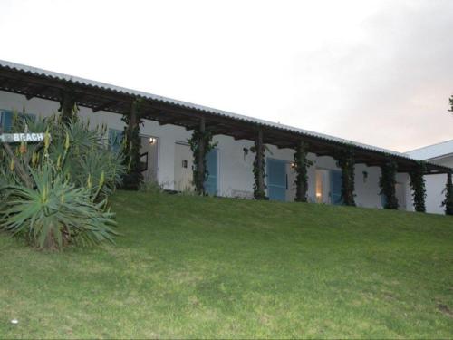 a building with a green yard in front of it at Glengariff Lodge in East London