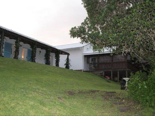 a house sitting on top of a grassy hill at Glengariff Lodge in East London