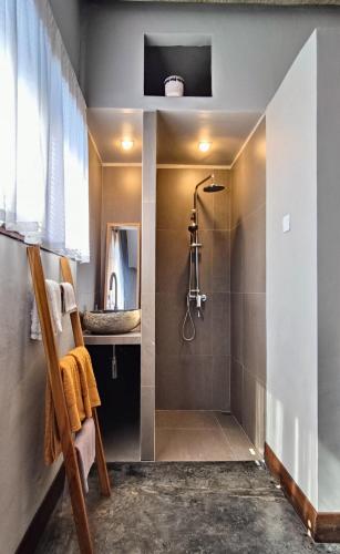 a bathroom with a shower and a sink at Dalai Tropical in Kuta Lombok