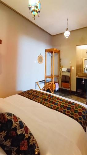 a hotel room with a bed and a bathroom at Dalai Tropical in Kuta Lombok