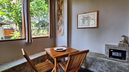 a table and chairs in a room with a window at Dalai Tropical in Kuta Lombok