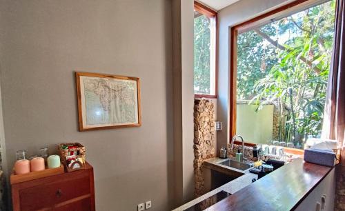 a bathroom with a sink and a mirror at Dalai Tropical in Kuta Lombok
