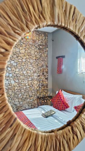 a reflection of a bedroom with a bed in a mirror at Dalai Tropical in Kuta Lombok