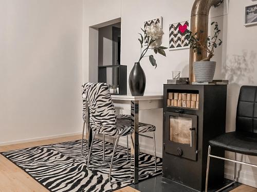 a room with a desk with a zebra print chair at Vaasa homestay in Vaasa