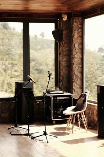 a room with a recording studio with a table and chairs at Giăng's House Farmstay & Glamping in Bao Loc