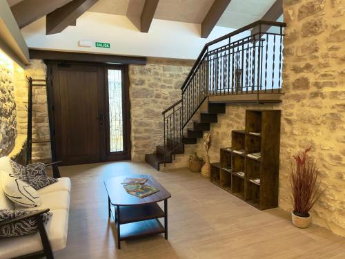 a living room with a staircase and a table at Casa Rural Barbarin in Barbarín