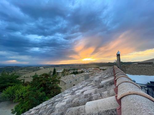 a view of a sunset from a wall with a lighthouse at Casa Rural Barbarin in Barbarín