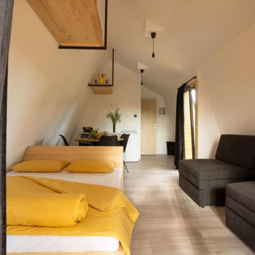 a bedroom with two beds and a couch at Glamping House Two Rivers in Ljubuški