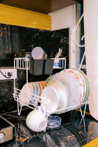 a bunch of dishes in a dish rack in a kitchen at RB Modern Condos in Zamboanga