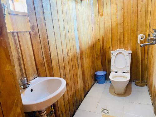 a wooden bathroom with a toilet and a sink at Kivu Macheo eco-lodge in Kibuye