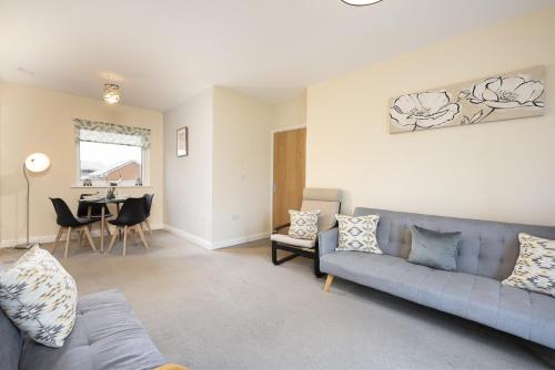 a living room with a couch and a table at Inaras place in Aylesbury