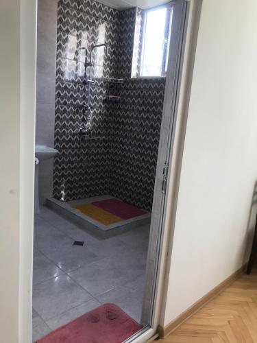 a shower with a glass door in a bathroom at gaydi in Gori