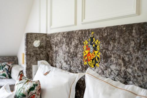 a butterfly decoration on a wall next to pillows at SCHLOSSRESIDENZ - Boutique Apartments & Hotel Suiten in Schloß Ricklingen
