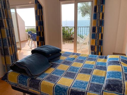 a bedroom with a bed with a view of the ocean at Bertur Cala Llevado in Tossa de Mar