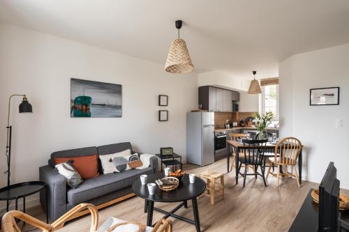 un salon avec un canapé et une table dans l'établissement Le Cargo - A 300m de la plage de Rochebonne, à Saint-Malo