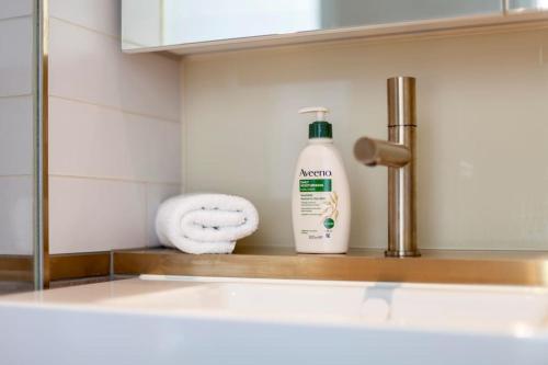 a bottle of mouthwash sitting on a shelf in a bathroom at Fantastic immense 1 BR flat, Battersea Power St in London