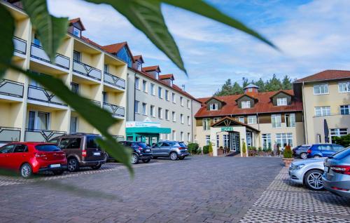a group of cars parked in a parking lot at Ferien Hotel Spree-Neisse in Neuhausen