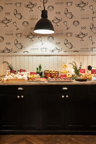 a kitchen with a counter with food on it at Grand Hôtel Mölle in Mölle
