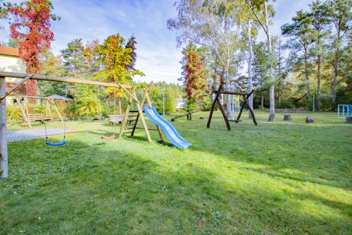 a playground with two swings in a park at Ferien Hotel Spree-Neisse in Neuhausen