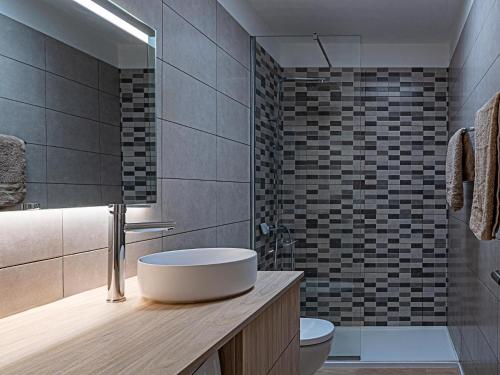 a bathroom with a sink and a toilet at Canaima Sea View/Terrace/Pool in Mogán