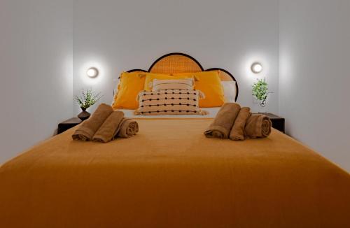 a bedroom with a large bed with orange sheets and pillows at Canaima Sea View/Terrace/Pool in Mogán