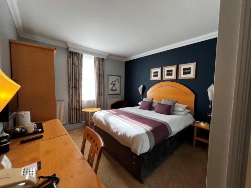 a hotel room with a bed and a desk at Blackwell Grange Hotel in Darlington