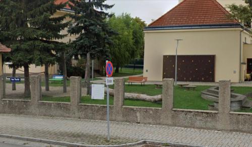 a fence in front of a park with a building at Golden Gate Orth an der Donau in Orth an der Donau