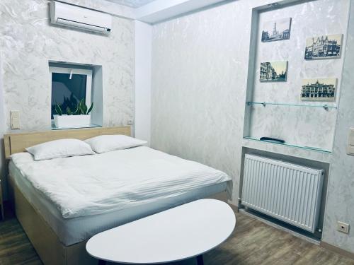 a small room with a bed and a stool at Kharkovlux in Kharkiv