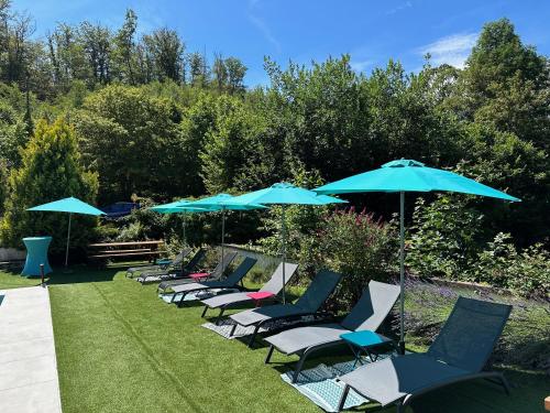 a row of chairs and umbrellas on the grass at Villa Moncoeur in Remiremont