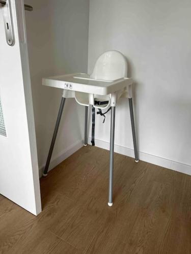 a small white table in a corner of a room at Le club green - appt 45 m2 - 4P - parking in Metz