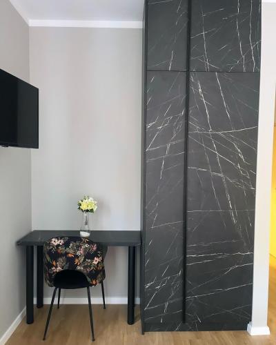a black door with a table and a chair at Casa Forrest & SPA in Muntele Săcelului