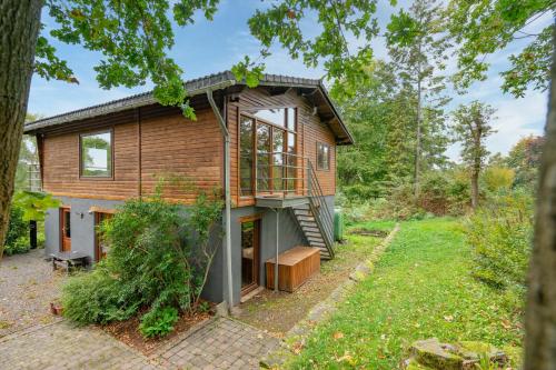 a house in the woods with a staircase at Au Ptit Bois Charmant in La Roche-en-Ardenne
