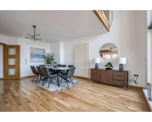 a living room with a dining room table and chairs at Central Belfast Apartments Pottinger's Quay in Belfast
