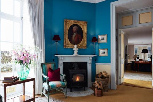 a living room with a fireplace and a painting on the wall at Loughcrew House in Oldcastle