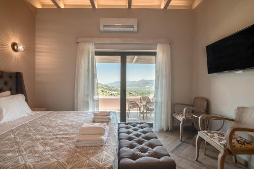 a bedroom with a large bed with a large window at Alexandras's Mansion - Alexinia's House in Ayiá