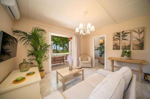 A seating area at Gaia Residences with lush garden and pool