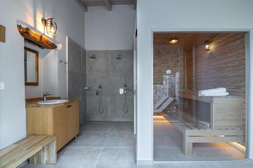 a bathroom with a shower and a sink at Alexandras's Mansion - Fragkia's House in Ayiá